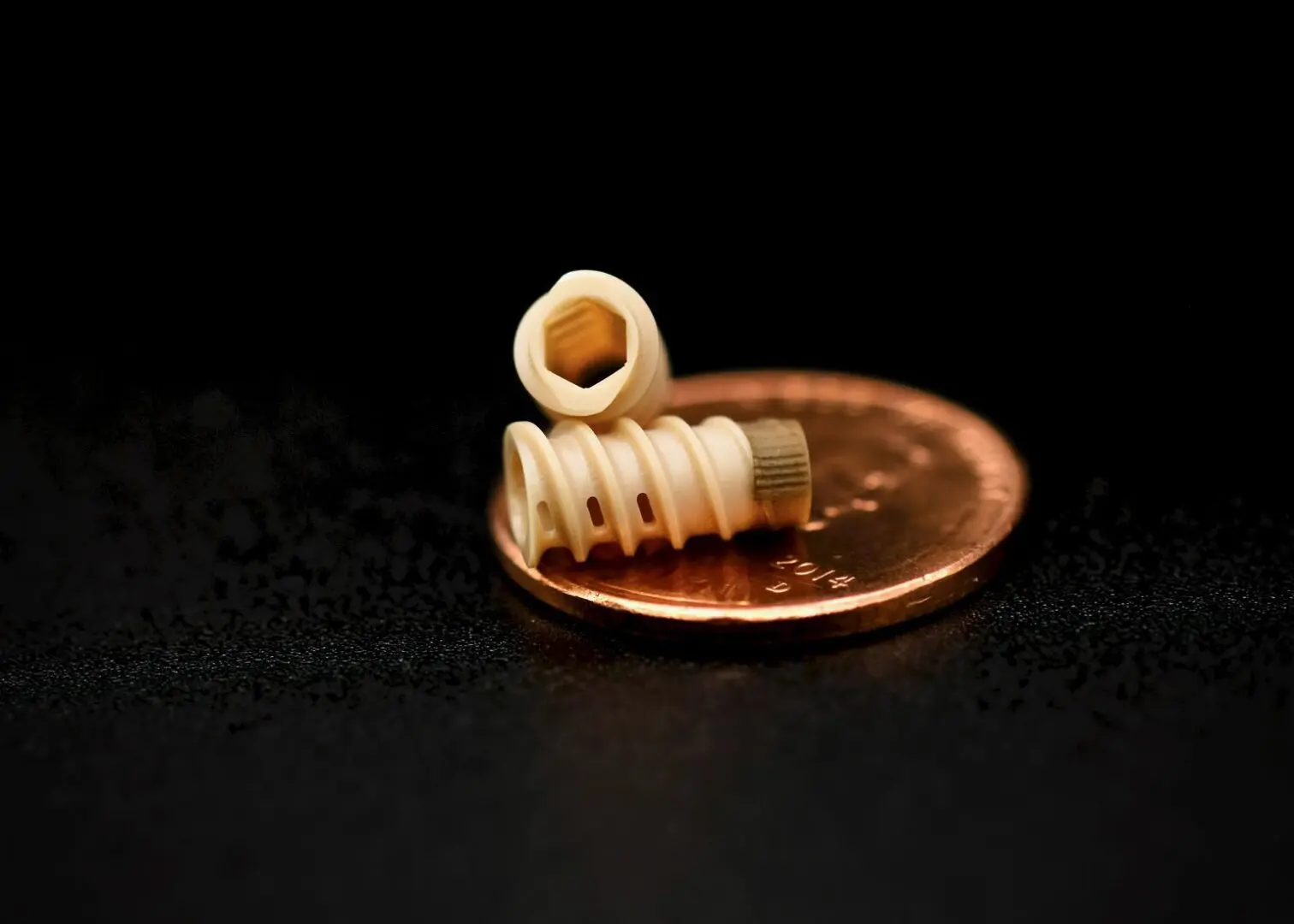 A penny with some white spiral wire on it