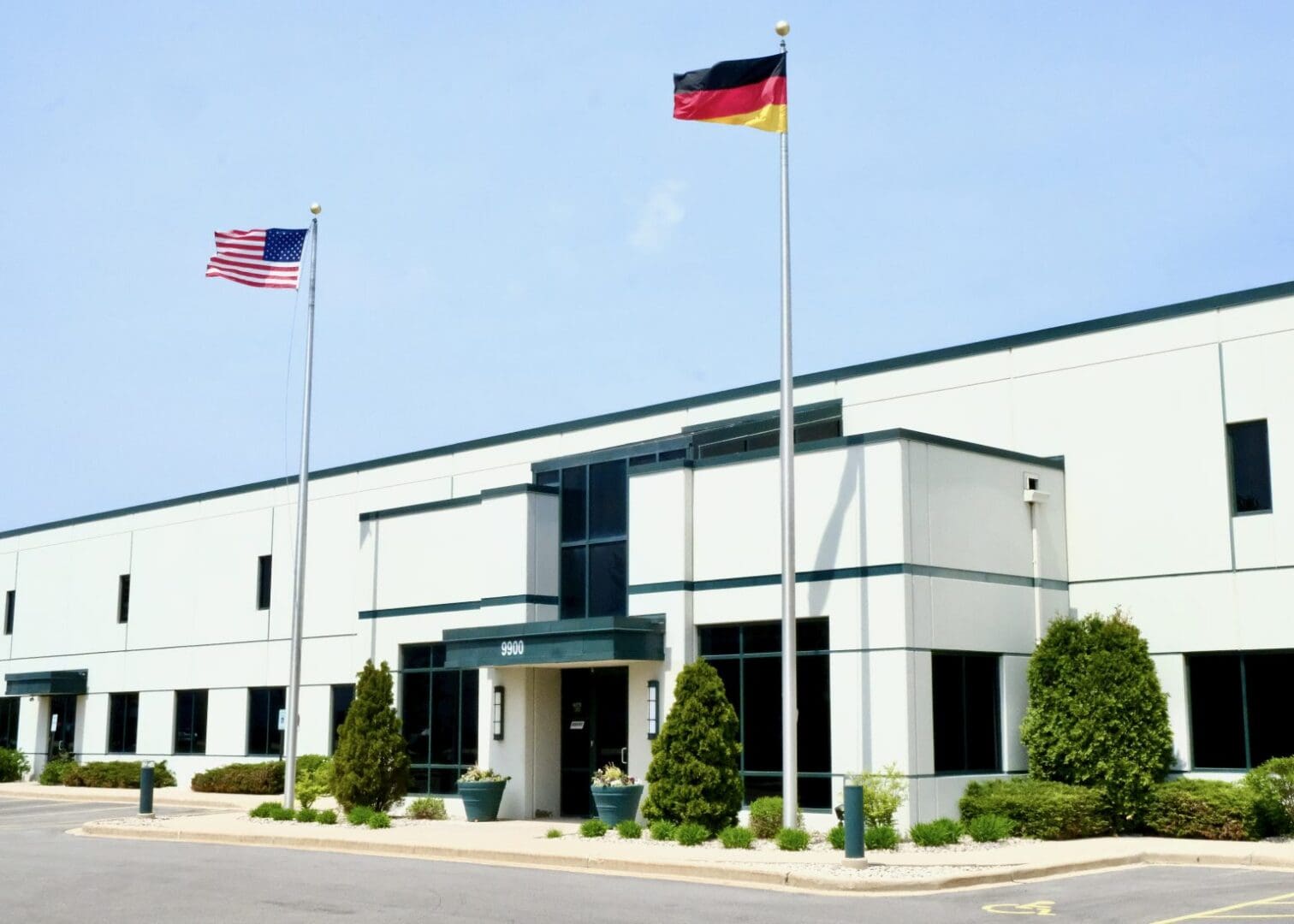 A building with two flags flying in front of it.