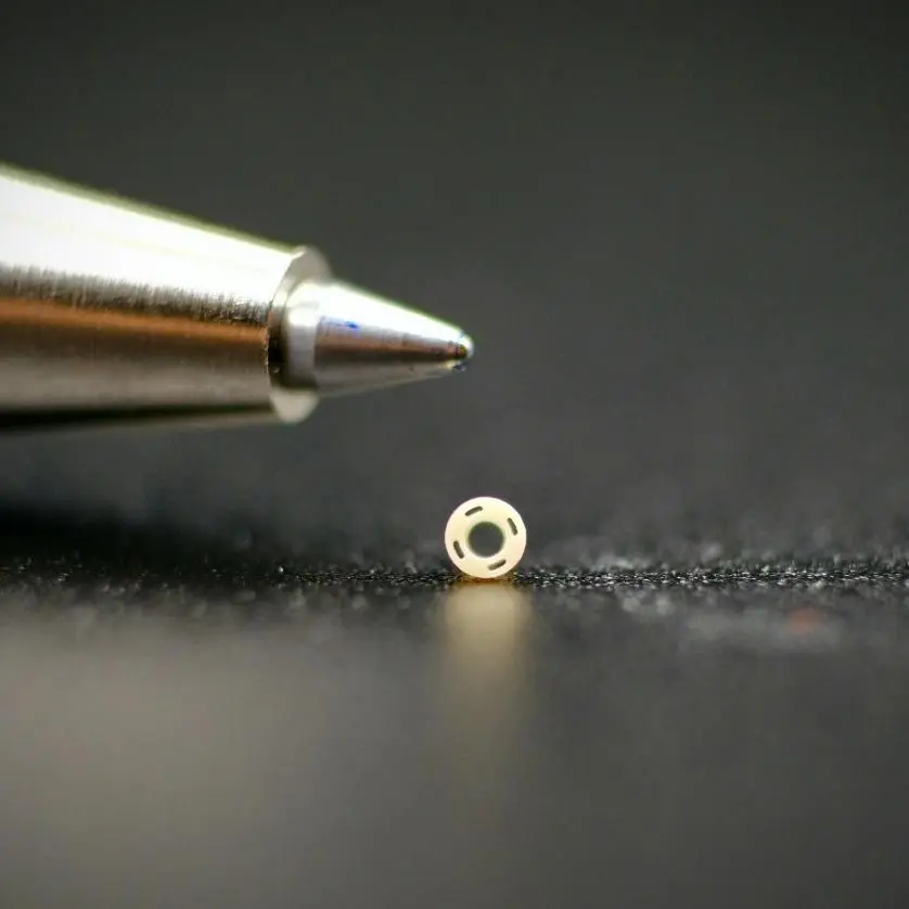 A close up of a pen and a small object