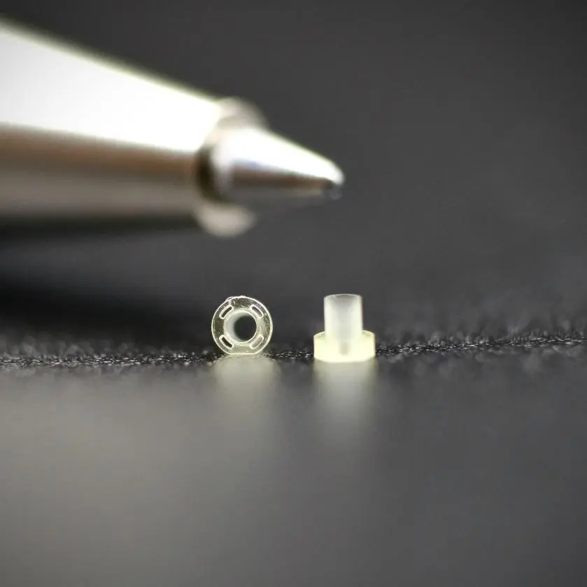 A close up of a small object next to a pen